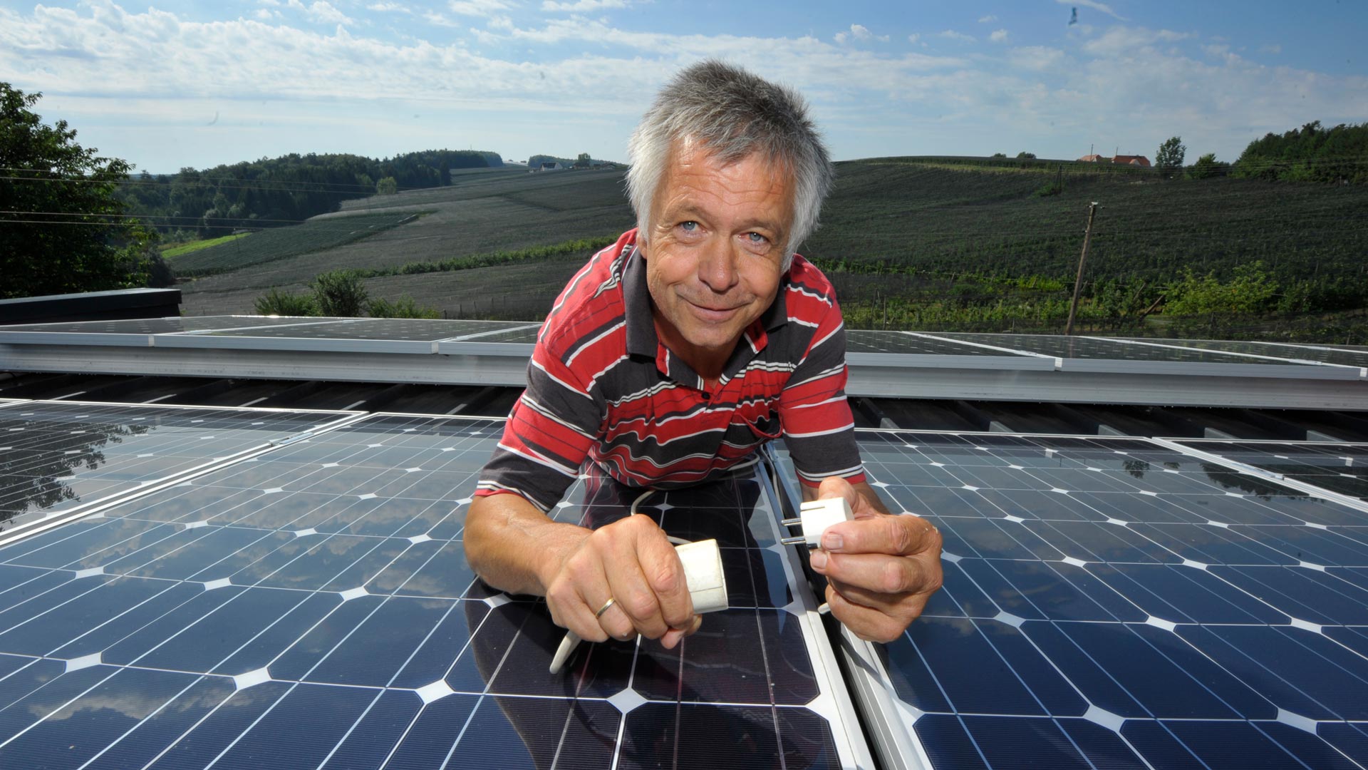Josef Wilhelm inmitten seiner Photovoltaik-Anlage am Dach seines Biomasse-Heizwerks.